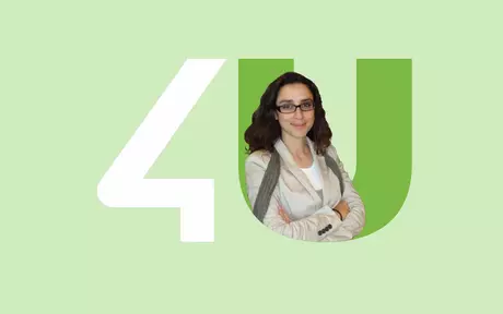 a smiling woman with her arms crossed in the 4U logo