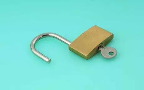 an unlocked padlock with the key inserted