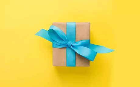 a parcel with a blue ribbon on a yellow background