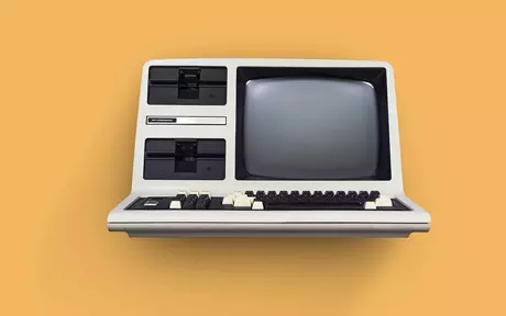 a retro pc from the early 80s on an orange background