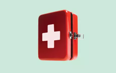First aid kit on green background