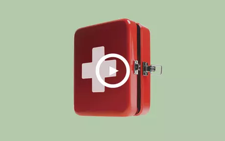 First aid kit on green background with play button