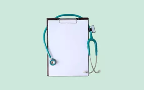 Clipboard and stethoscope on green background