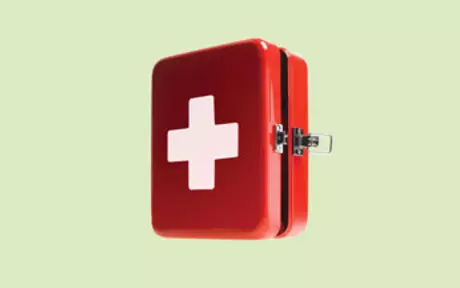 First aid kit on light green background