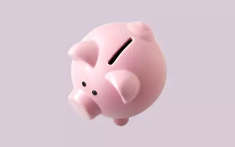 Piggy bank on mauve background