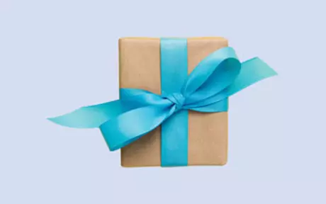 Gift box with blue ribbon on purple background