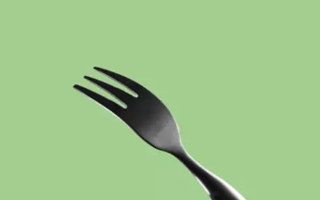 Fork on green background