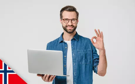 Smiling man with beard, glasses and a laptop