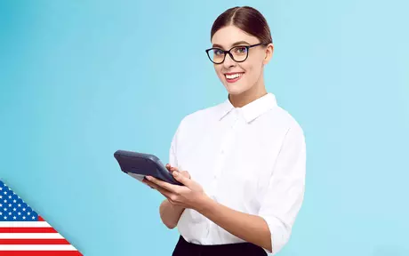 smiling woman holding large calculator in both hands