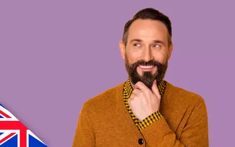 Smiling man with beard on purple background