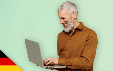 Man smiling at laptop screen