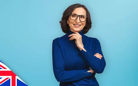 Smiling woman with glasses on blue background