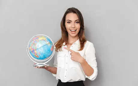 girl in white shirt pointing to  globe
