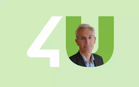 men in suit in unit4 logo green background