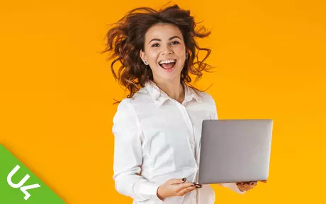 Laughing woman, holding laptop, orange background