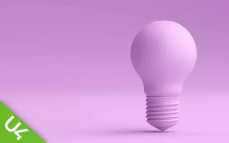 Lilac coloured lightbulb on a lilac background